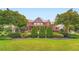 Elegant brick home with manicured lawn and mature trees, offering privacy and curb appeal at 692 Heritage Post Ln, Grayson, GA 30017