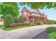 Lovely brick home with a covered porch, professional landscaping, and a curved driveway at 692 Heritage Post Ln, Grayson, GA 30017