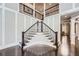 Grand foyer with curved staircase, decorative iron railings, and hardwood floors at 692 Heritage Post Ln, Grayson, GA 30017
