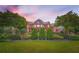 Beautiful home featuring mature trees, manicured bushes, and a well maintained lawn at 692 Heritage Post Ln, Grayson, GA 30017