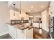 Bright kitchen featuring granite countertops, stainless steel appliances, and custom white cabinets at 692 Heritage Post Ln, Grayson, GA 30017