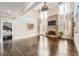 Bright living room featuring hardwood floors, fireplace, and large windows with natural light at 692 Heritage Post Ln, Grayson, GA 30017