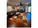 Spacious living room with hardwood floors, comfortable leather furniture, and a billiards room at 692 Heritage Post Ln, Grayson, GA 30017