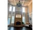 Grand living room featuring a stone fireplace, tall windows, and hardwood floors at 692 Heritage Post Ln, Grayson, GA 30017