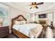 Spacious main bedroom featuring a fireplace, tray ceiling, and dark hardwood floors at 692 Heritage Post Ln, Grayson, GA 30017