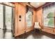 Office space featuring wood paneled walls, hardwood floors, and large windows at 692 Heritage Post Ln, Grayson, GA 30017