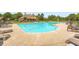 Large community pool surrounded by lounge chairs and tables for relaxing at 692 Heritage Post Ln, Grayson, GA 30017