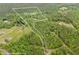 An aerial view of property lines bordering a large plot of land with dense trees and open fields at 7 Perkins Mountain Rd, Kingston, GA 30145