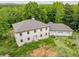 An aerial view of a large two-story house with an attached garage surrounded by trees at 7 Perkins Mountain Rd, Kingston, GA 30145