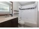 Bathroom featuring a dark wood vanity, with a tub shower combo featuring black and white tiles at 986 Greenwood Ne Ave # 4, Atlanta, GA 30306