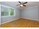 Empty bedroom featuring a ceiling fan, window, hardwood floors, and neutral walls at 986 Greenwood Ne Ave # 4, Atlanta, GA 30306