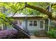 Apartment exterior with a black metal stairway and lush foliage surrounding the building at 986 Greenwood Ne Ave # 4, Atlanta, GA 30306
