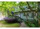 Apartment exterior with a black metal stairway and lush foliage surrounding the building at 986 Greenwood Ne Ave # 4, Atlanta, GA 30306