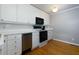 Bright kitchen with stainless steel dishwasher and range hood, complimented by stylish cabinets and hardwood floors at 986 Greenwood Ne Ave # 4, Atlanta, GA 30306