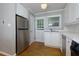 Well-lit kitchen featuring stainless steel appliances, white cabinetry, and hardwood floors at 986 Greenwood Ne Ave # 4, Atlanta, GA 30306