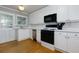 Bright kitchen featuring white cabinetry, modern appliances, and an exterior door at 986 Greenwood Ne Ave # 4, Atlanta, GA 30306