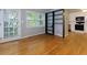 Spacious living room with hardwood floors and a dark built-in shelving unit at 986 Greenwood Ne Ave # 4, Atlanta, GA 30306