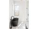 Modern bathroom featuring a freestanding black bathtub and a frameless glass shower at 11530 Serenbe Ln, Chattahoochee Hills, GA 30268