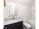 Bright bathroom with a black vanity, gold faucet, light walls, and a combined shower and bath at 11530 Serenbe Ln, Chattahoochee Hills, GA 30268