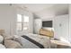 Bright bedroom featuring large windows, white walls, wood floors, and modern furniture at 11530 Serenbe Ln, Chattahoochee Hills, GA 30268