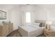 Bright bedroom with neutral colors, a modern bed, hardwood floors, and an arched window at 11530 Serenbe Ln, Chattahoochee Hills, GA 30268