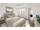 Serene main bedroom featuring a tray ceiling, natural light, and an ensuite bathroom at 11530 Serenbe Ln, Chattahoochee Hills, GA 30268