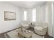 Cozy sitting room featuring neutral decor, hardwood floors, and natural light at 11530 Serenbe Ln, Chattahoochee Hills, GA 30268