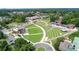Overhead shot of a charming park offering a lush amphitheater, well-kept lawns, and convenient parking facilities at 116 Via Roma, Woodstock, GA 30188