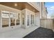 Exterior patio with mulched yard, wooden fence, and lots of light to the home's interior at 116 Via Roma, Woodstock, GA 30188