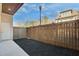 Fenced backyard with dark mulch and a gate, creating a cozy and private outdoor space at 116 Via Roma, Woodstock, GA 30188