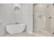 Elegant bathroom with a sleek soaking tub and a glass-enclosed shower at 116 Via Roma, Woodstock, GA 30188