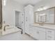 Bright bathroom featuring dual sinks, modern fixtures, and ample cabinet space at 116 Via Roma, Woodstock, GA 30188