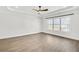 Spacious bedroom featuring hardwood floors, tray ceiling and large windows at 116 Via Roma, Woodstock, GA 30188