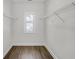Spacious walk-in closet with wood-look floors and wire shelving at 116 Via Roma, Woodstock, GA 30188