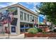 Commercial brick building with a colorful mural and storefront windows offering a vibrant and inviting street view at 116 Via Roma, Woodstock, GA 30188