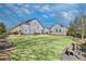 Well-maintained common area with a lush green lawn, seating, and townhouse views at 116 Via Roma, Woodstock, GA 30188