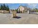 Welcoming entrance to the Tuscany Village community featuring a stone facade at 116 Via Roma, Woodstock, GA 30188