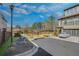 Upscale neighborhood exterior featuring well-maintained lawns, trees, and street lighting at 116 Via Roma, Woodstock, GA 30188