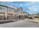 Back exterior view of these townhomes with a view of garages and landscaping at 116 Via Roma, Woodstock, GA 30188
