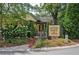 Charming Century House Tavern with beautiful landscaping and sign at 116 Via Roma, Woodstock, GA 30188