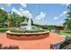 Scenic fountain surrounded by benches and greenery, creating a peaceful and inviting public space at 116 Via Roma, Woodstock, GA 30188
