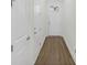Bright hallway featuring hardwood floors, white walls, and access to other areas of the home at 116 Via Roma, Woodstock, GA 30188