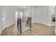 Hallway featuring a curved railing, open floor and laundry room at 116 Via Roma, Woodstock, GA 30188