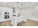 Contemporary kitchen with white cabinets, stainless appliances, and a large central island at 116 Via Roma, Woodstock, GA 30188