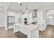 Stylish kitchen with white cabinets, pendant lighting, a center island, and modern appliances at 116 Via Roma, Woodstock, GA 30188