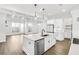 Bright, modern kitchen with white cabinets, stainless appliances, and a large center island at 116 Via Roma, Woodstock, GA 30188