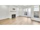 Bright living room featuring a cozy fireplace and access to an outdoor patio at 116 Via Roma, Woodstock, GA 30188