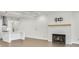 Bright, modern living room featuring a fireplace, hardwood floors, and an open layout to kitchen at 116 Via Roma, Woodstock, GA 30188