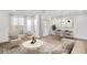 Staged living room featuring neutral tones, large windows, and a dining area for modern living at 116 Via Roma, Woodstock, GA 30188