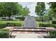 Solemn 9/11 memorial with stone monuments, landscaping, and benches, offering a space for reflection and remembrance at 116 Via Roma, Woodstock, GA 30188
